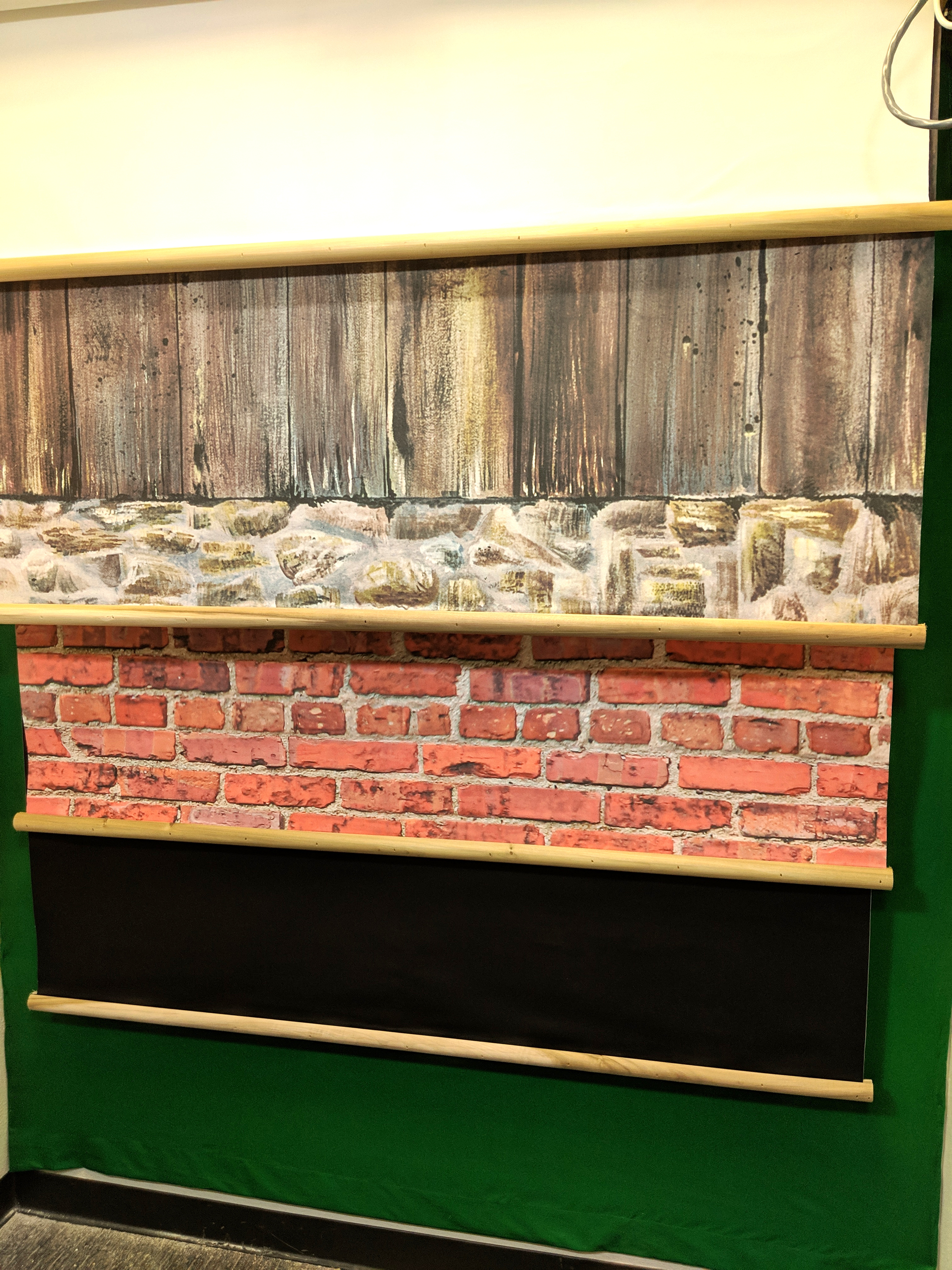 4 drop down backdrops and a green screen wall