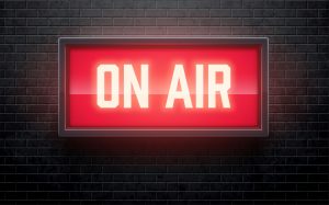 Lighted "On Air"white lettering on red background